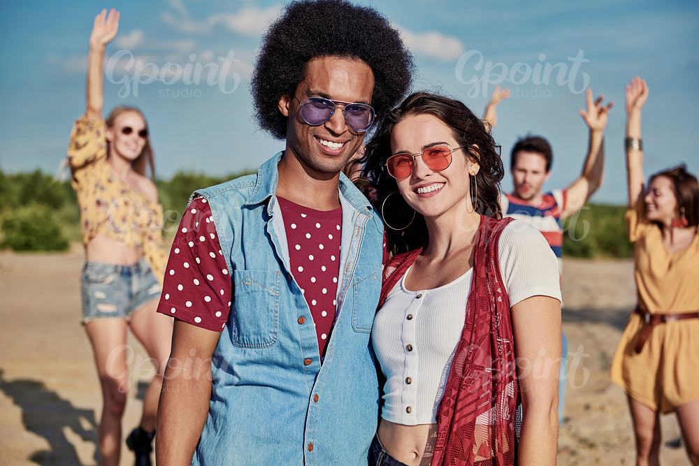 Portrait of smiling young couple on the beach party