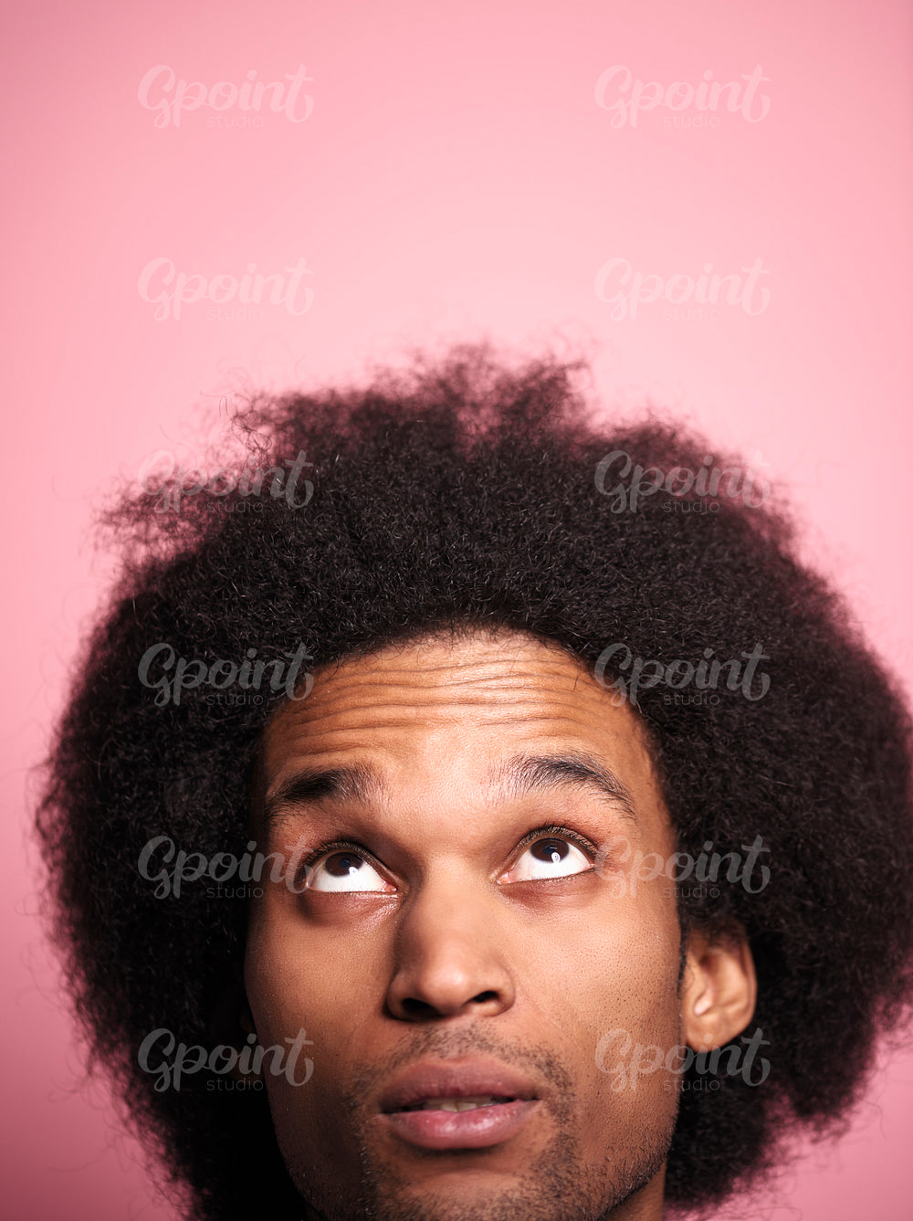 Close up African man looking up in studio shot.
