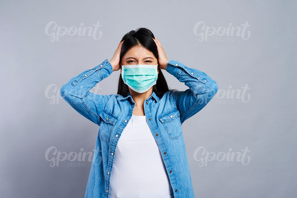 Paranoid Asian woman in protective mask