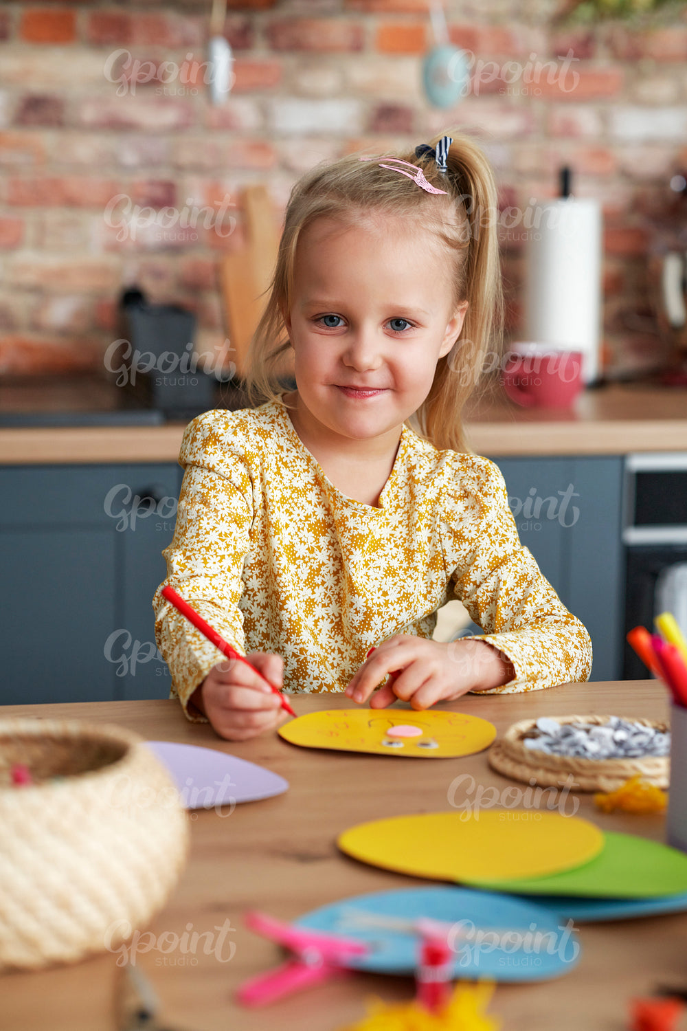 Portrait of cute girl painting by colorful pencil at home