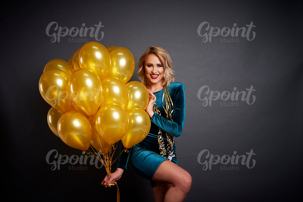 Happy woman with balloons in studio shot