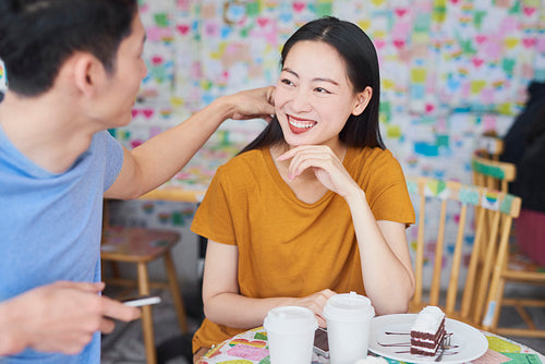 Young couple having happy time in a cafe