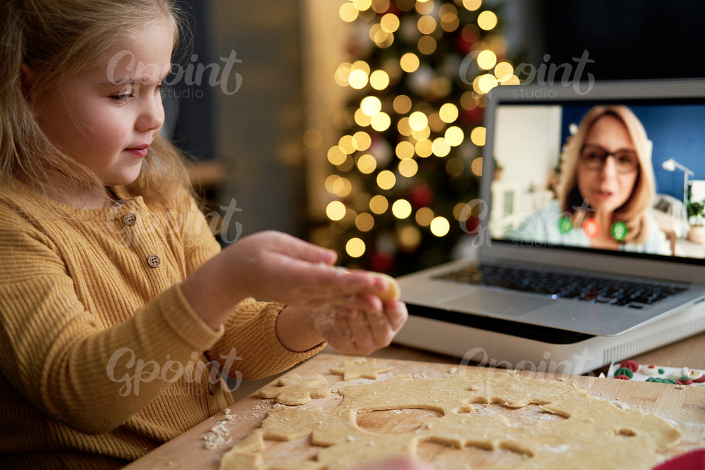 Close up of granddaughter showing her grandma Christmas cookies