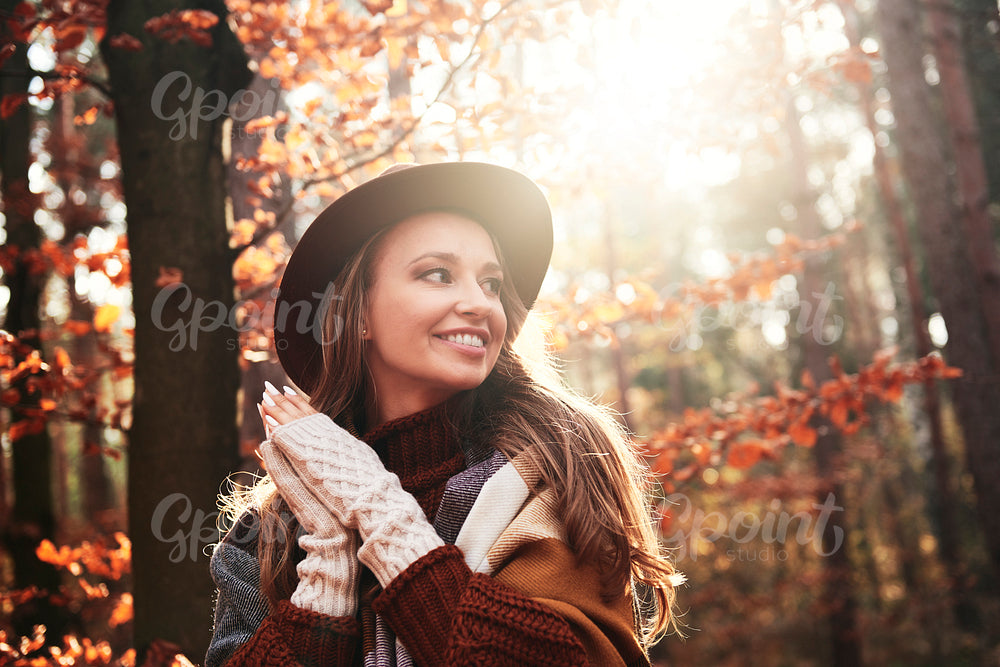 Smiling young woman in autumnal forest