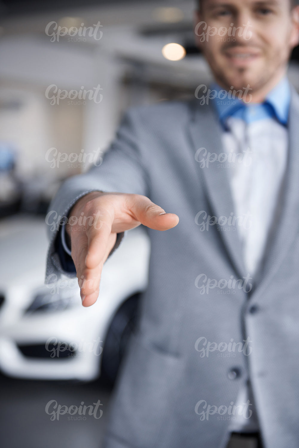 Car dealer reaching out his hand