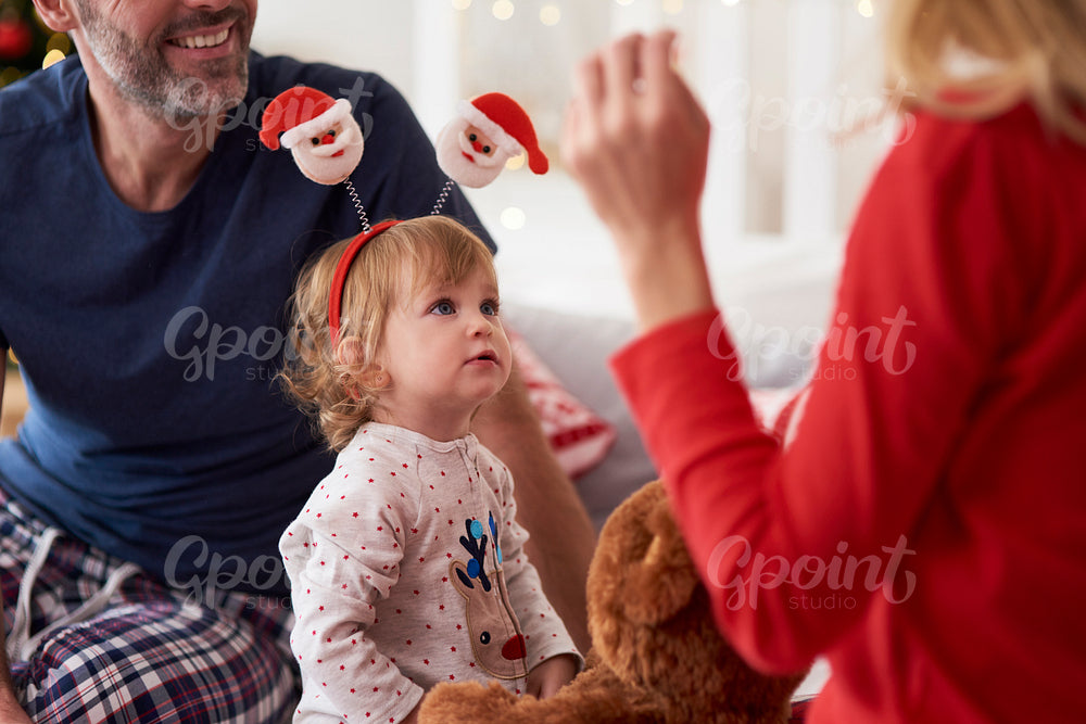 Happy baby with parents in Christmas morning