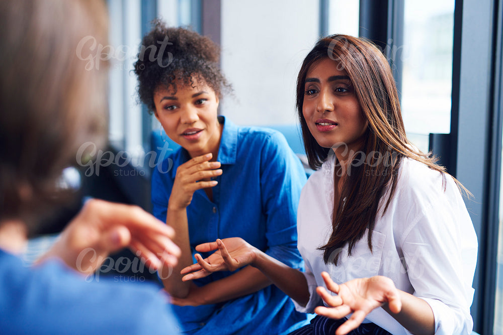 Woman explaining business strategy to coworkers