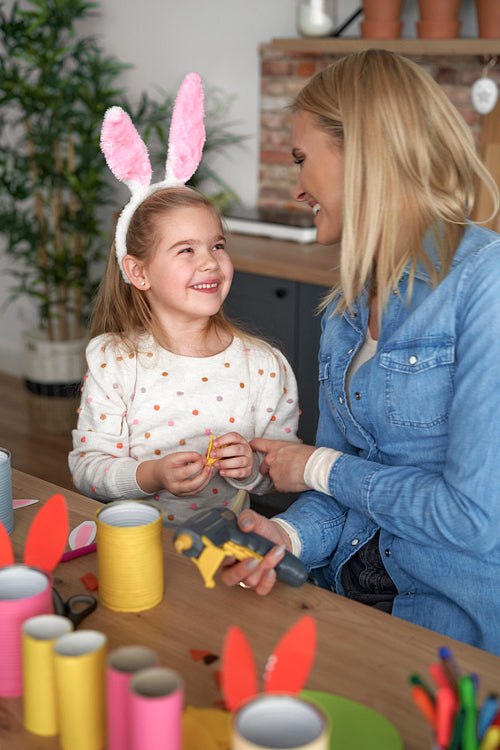 Happy mom and daughter preparing Easter decorations together