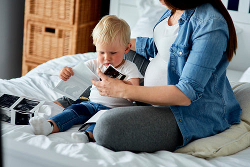 Woman and her little son browsing ultrasound images