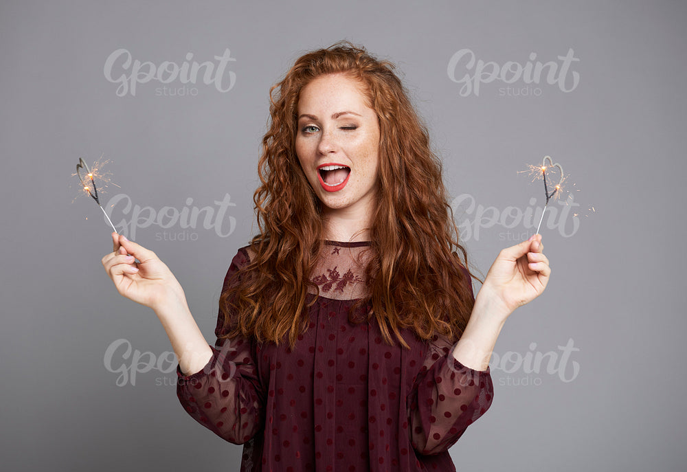 Shot of screaming woman showing heart shaped sparklers