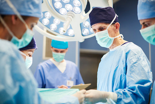 Group of busy doctors in operating room