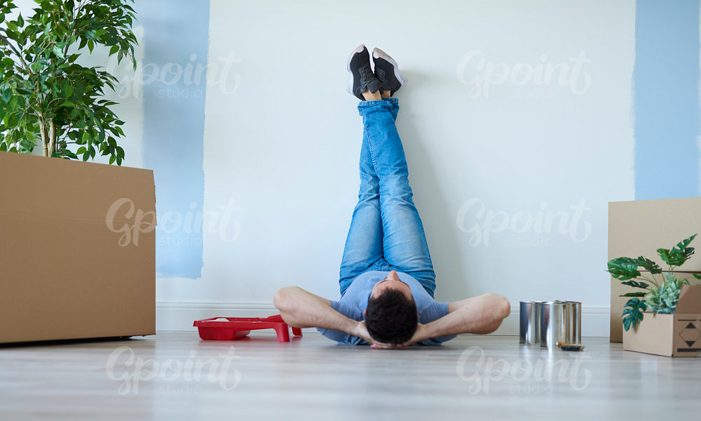 Rear view of man catching a break during moving house