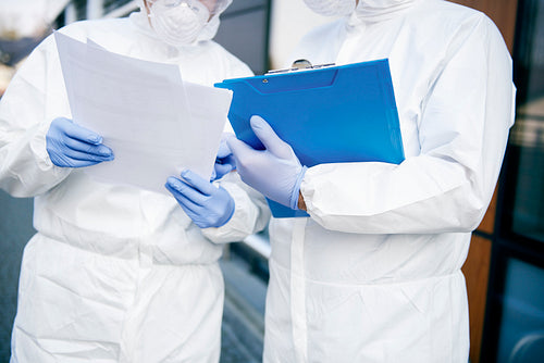 Close up of two technicians with documents