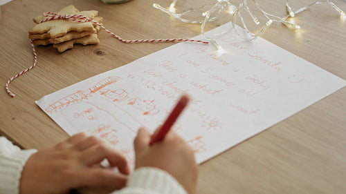 Tilt up video of children writing creative letters to Santa Claus