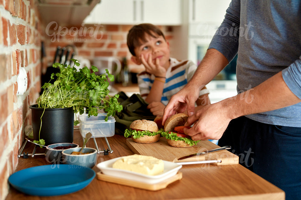 Close up of father making lunch for son in kitchen