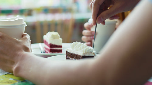 Handheld view of man feeding woman dessert on a date.