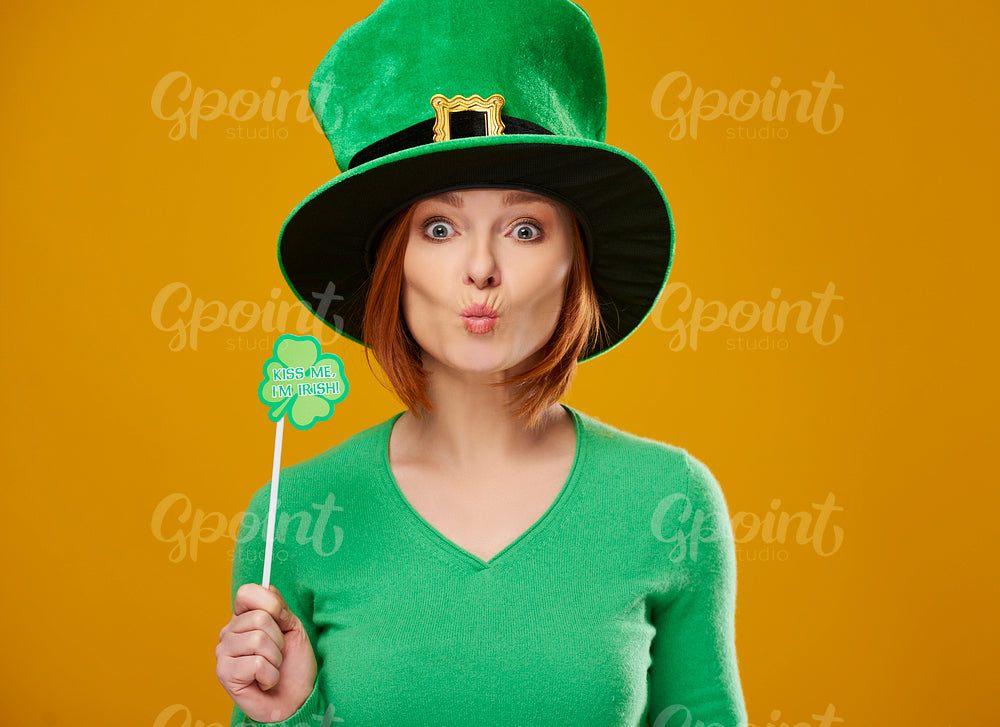 Happy leprechaun with green hat blowing a kiss