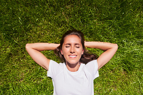 Top view of woman lying on the grass