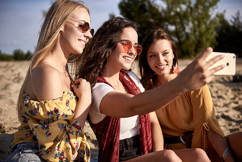 Three girls taking a selfie at the beach