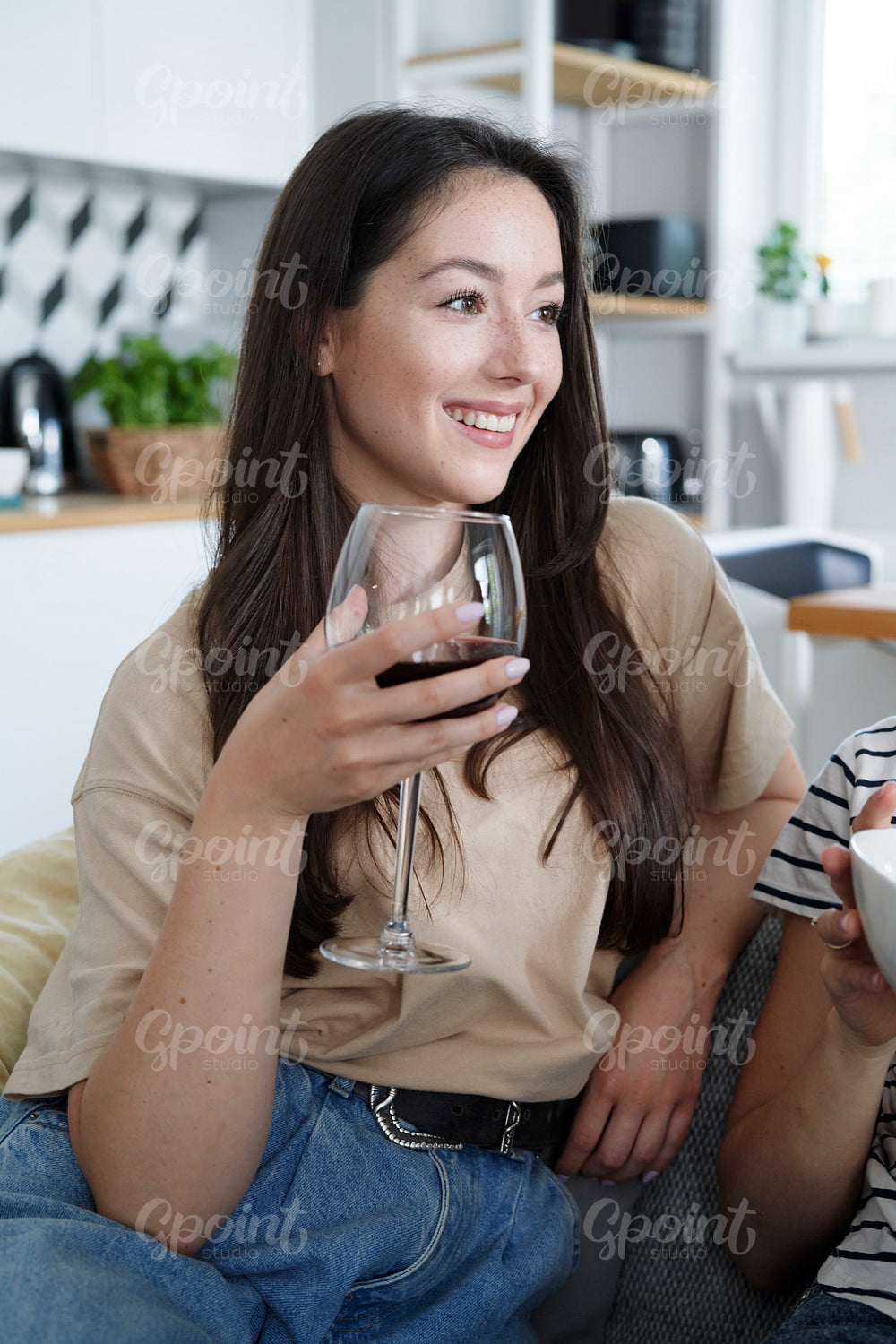 Smiling woman with a glass of wine in hand