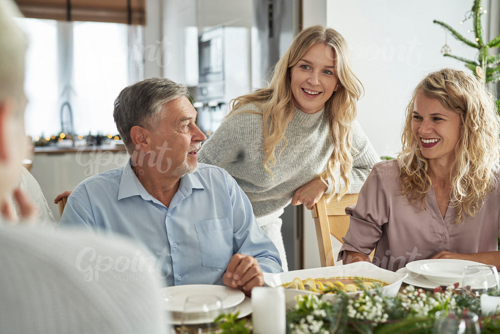 Caucasian family spending time over table at Christmas dinner 