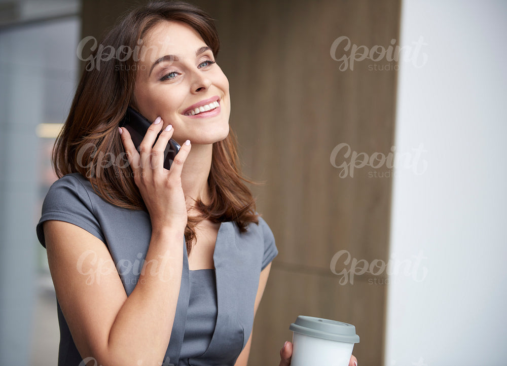 Talking on the phone and having coffee