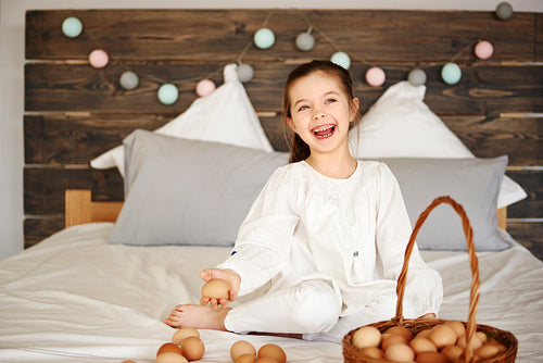 Happy child having fun with eggs