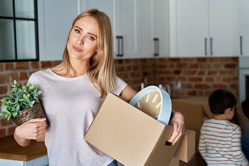 Portrait of woman with a cardboard box during moving