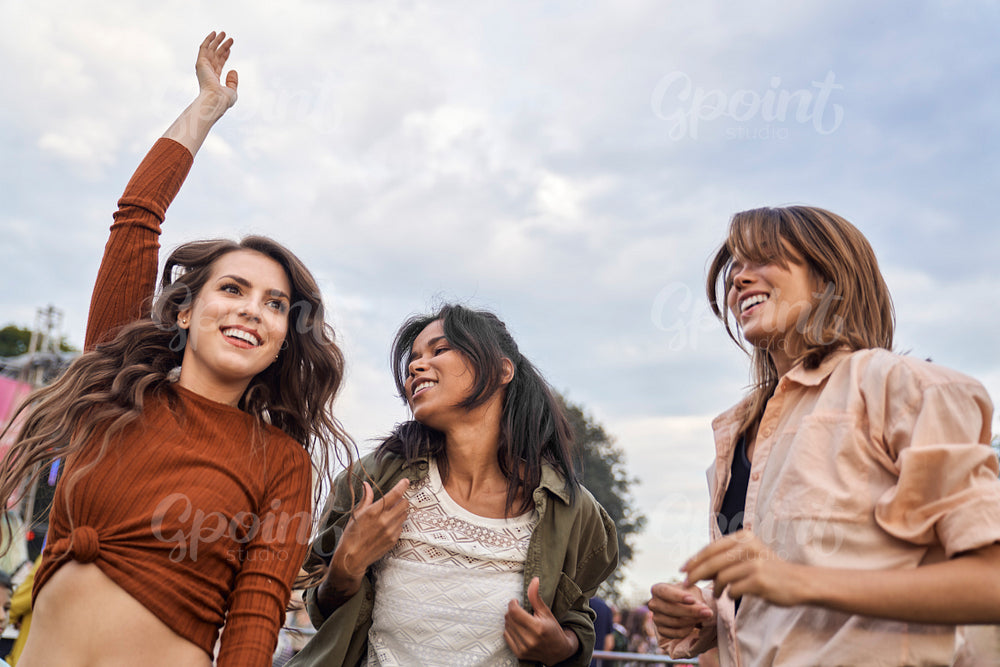 Group of multiracial friends have fun at music festival  