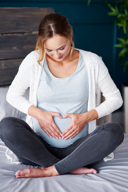 Affectionate pregnant woman touching her stomach