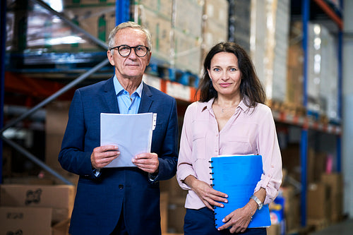 Portrait of caucasian business mature man and woman in the warehouse