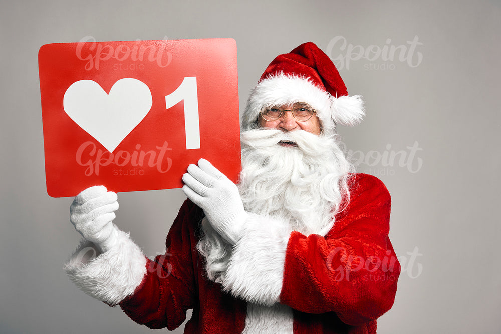 Caucasian Santa Claus holding red poster with 'like' 