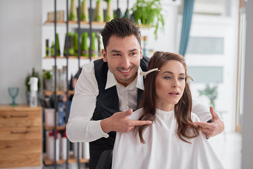 Male hairdresser giving woman good advice
