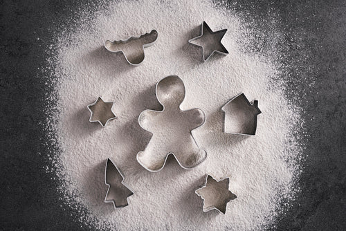 Mix of Christmas cookie cutter and flour