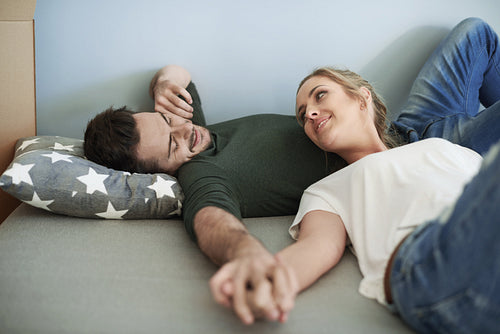 Woman and man having rest during moving house