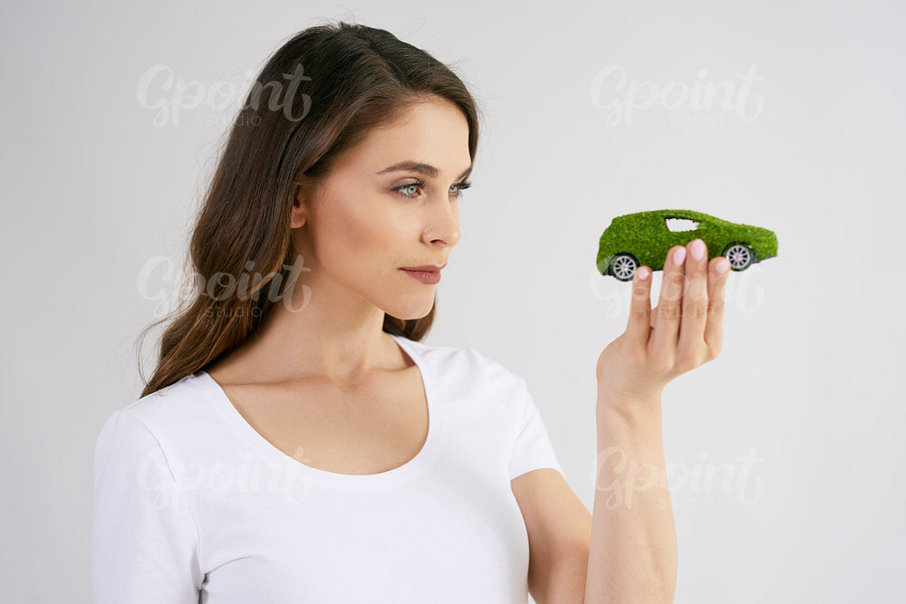 Woman looking at eco friendly car