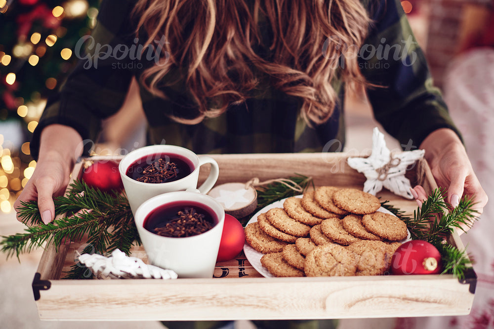Unrecognizable woman holding tray with snack