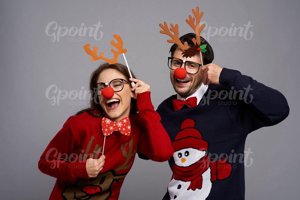 Portrait of couple with funny reindeer gadgets