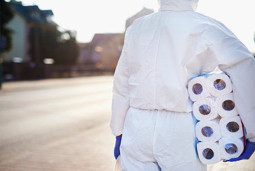 Person with toilet paper wearing a protective suit