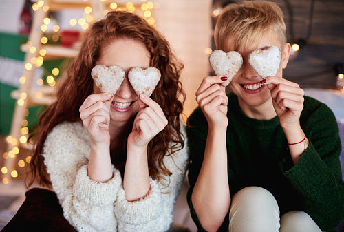 Girls holding heart shaped gingerbread cookies