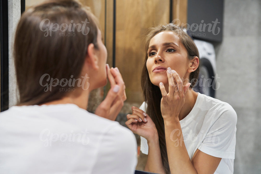Woman browsing face in the mirror