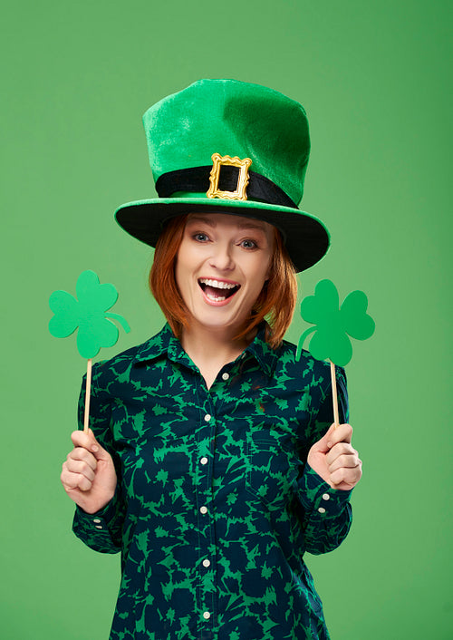 Portrait of smiling leprechaun with clover shaped banner