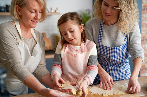 Three generations of women preparing Easter cookies
