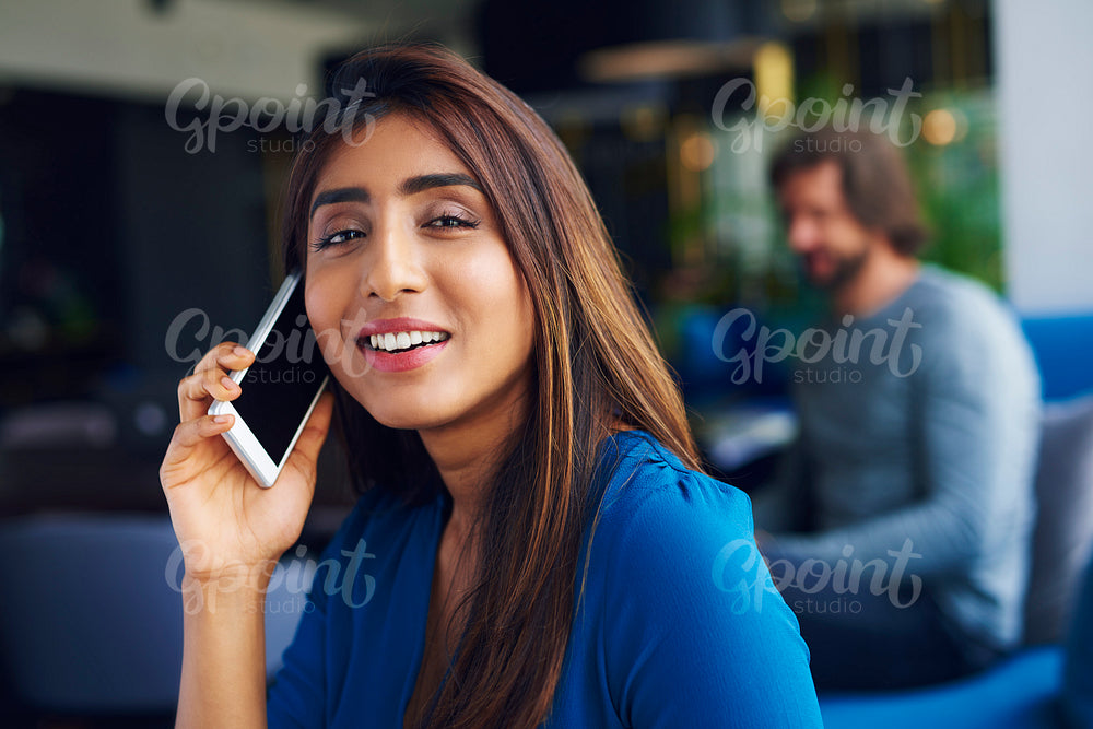 Waist up of Asian woman on the phone