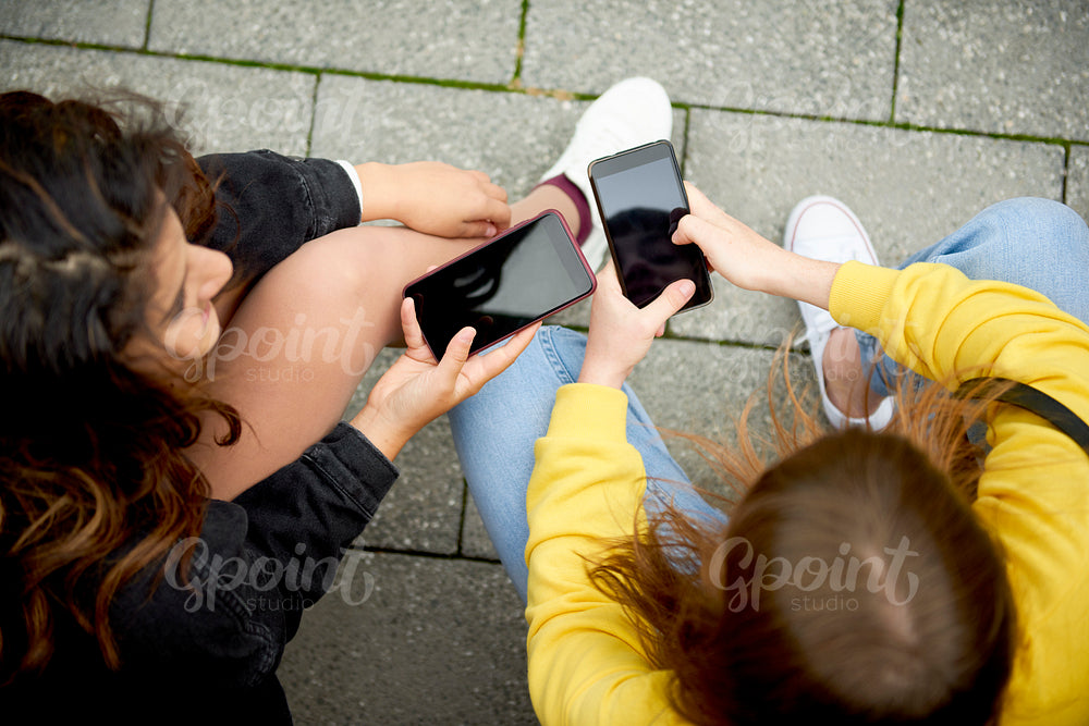 High angle view of girls with mobile phone