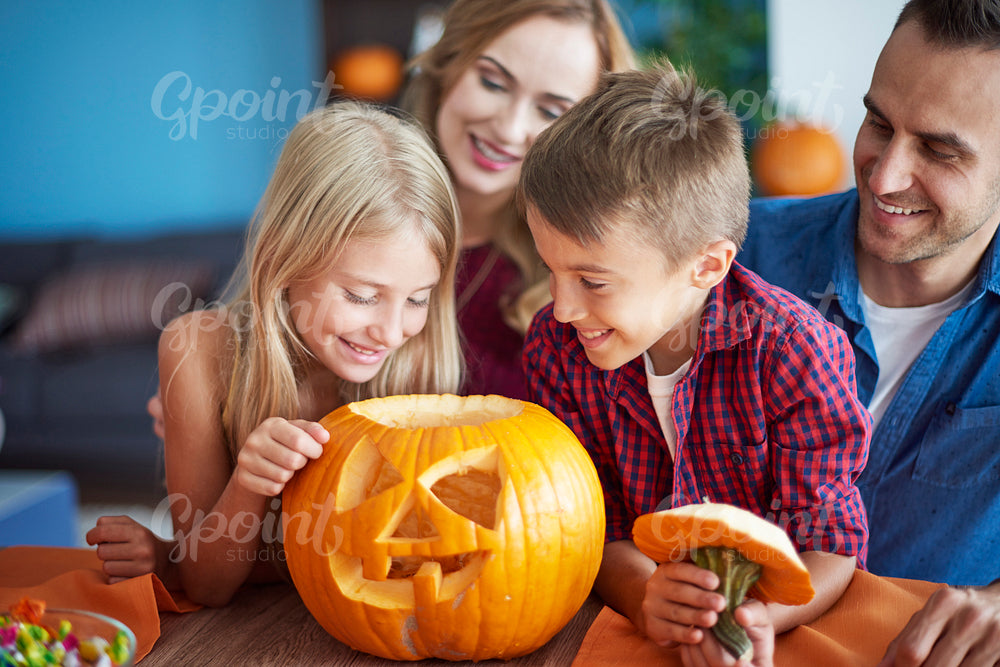 Family with scary Halloween pumpkin