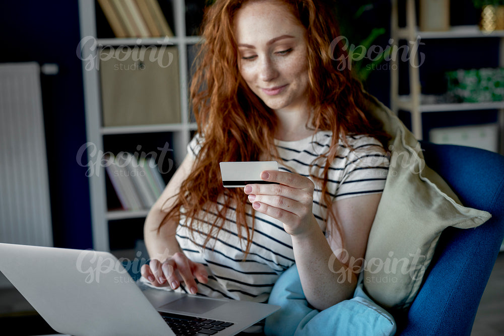 Young woman doing e-shopping at home