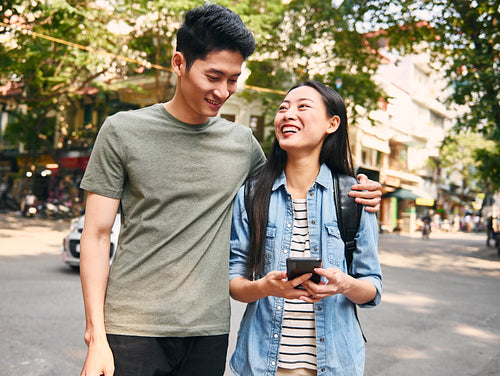 Young couple with smart phone in the city