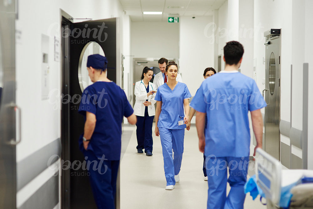 Doctors walking through corridor in hospital