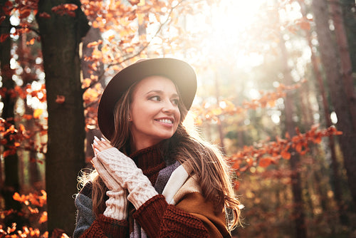 Smiling young woman in autumnal forest